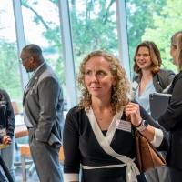 Three event guests standing together in conversation